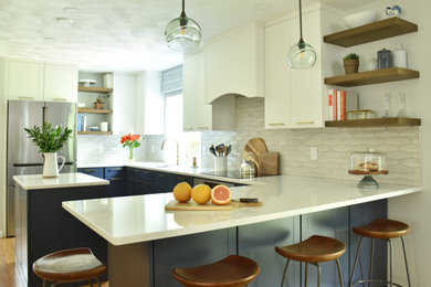 Kitchen - mid-sized u-shaped light wood floor kitchen idea in Boston with an undermount sink, flat-panel cabinets, blue cabinets, quartz countertops, gray backsplash, ceramic backsplash, stainless steel appliances, an island and white countertops