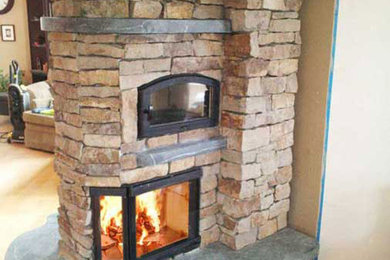 Inspiration for a mid-sized timeless open concept ceramic tile living room library remodel in Denver with a two-sided fireplace, a stone fireplace and no tv