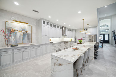 Inspiration for a large transitional galley ceramic tile and gray floor eat-in kitchen remodel in Houston with an undermount sink, shaker cabinets, gray cabinets, gray backsplash, ceramic backsplash, stainless steel appliances, two islands and white countertops
