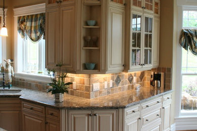 Inspiration for a large transitional l-shaped medium tone wood floor open concept kitchen remodel in New York with an undermount sink, raised-panel cabinets, white cabinets, stainless steel appliances, an island, solid surface countertops, gray backsplash and stone slab backsplash