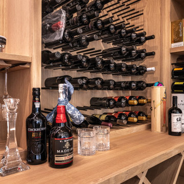Custom Wine Cellar Modern White Oak Cabinetry with Black Wine Pegs and Rods