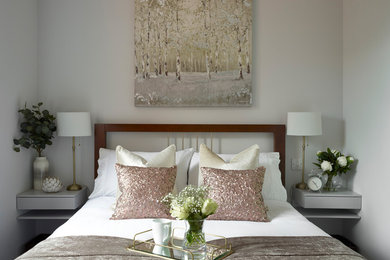 Example of a minimalist guest carpeted and gray floor bedroom design in Essex with gray walls