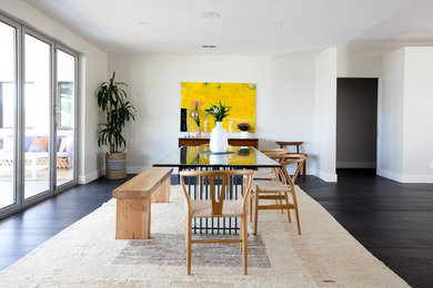 Trendy dark wood floor kitchen/dining room combo photo in Los Angeles with white walls