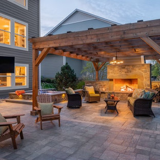 Inspiration for a large backyard full sun garden in Minneapolis with with fireplace and natural stone pavers.