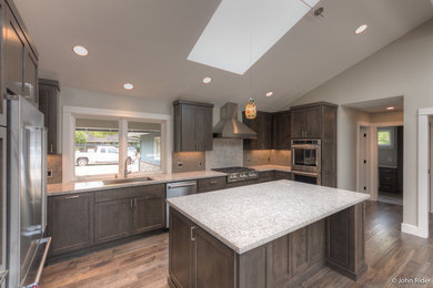 Kitchen - mid-sized contemporary u-shaped dark wood floor kitchen idea in San Francisco with brown cabinets, brown backsplash, glass tile backsplash, stainless steel appliances and an island