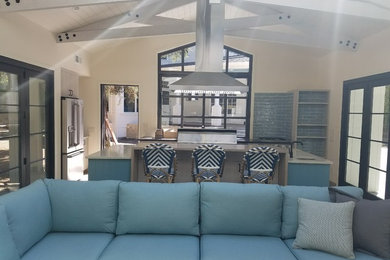 Example of a large beach style backyard concrete paver and custom-shaped infinity pool house design in San Francisco