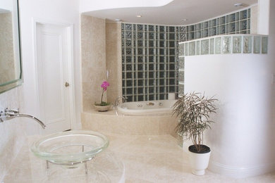 Inspiration for a contemporary limestone floor and beige floor bathroom remodel in Other with beige walls and a vessel sink