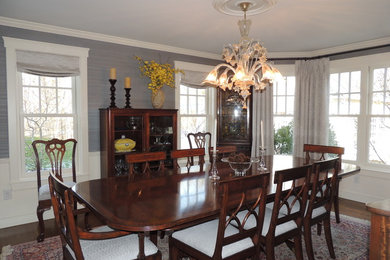 Photo of a mid-sized traditional separate dining room in Boston with blue walls, dark hardwood floors and brown floor.