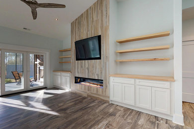 Living room - large open concept living room idea in Other with a ribbon fireplace, a wood fireplace surround and a media wall