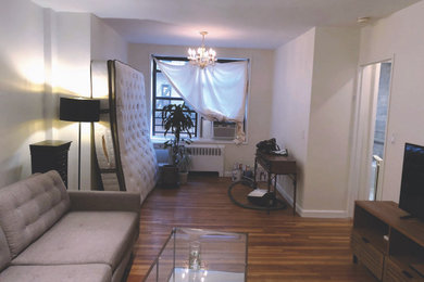 Inspiration for a mid-sized family room remodel in New York with white walls