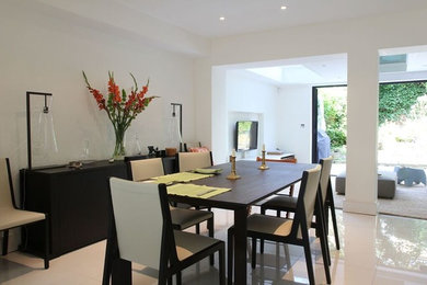 Trendy ceramic tile dining room photo in London with white walls