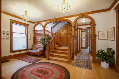Ornate light wood floor foyer photo in Other with white walls