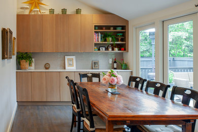 На фото: кухня среднего размера в современном стиле с обеденным столом, плоскими фасадами, светлыми деревянными фасадами, столешницей из кварцевого агломерата, островом и белой столешницей
