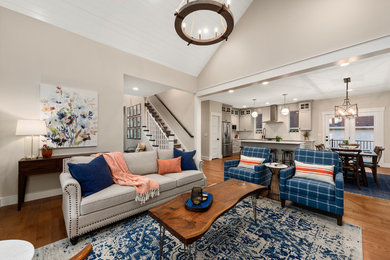 Mid-sized transitional open concept medium tone wood floor living room photo in Salt Lake City with a standard fireplace, a brick fireplace and a wall-mounted tv