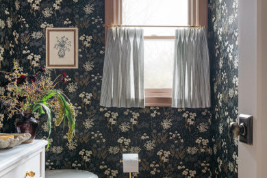 Elegant medium tone wood floor, brown floor and wallpaper bathroom photo in Chicago with recessed-panel cabinets, white cabinets, multicolored walls, white countertops and a freestanding vanity