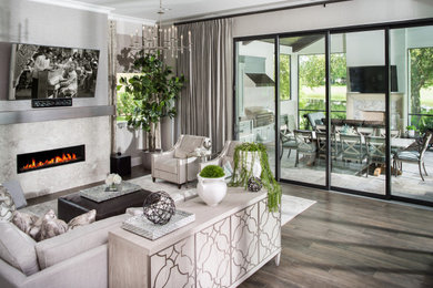 Inspiration for a large transitional open concept porcelain tile and brown floor family room remodel in Orlando with gray walls, no fireplace, a stone fireplace and a wall-mounted tv