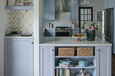 Example of a mid-sized classic medium tone wood floor eat-in kitchen design in Chicago with a farmhouse sink, raised-panel cabinets, blue cabinets, quartz countertops, white backsplash and yellow countertops