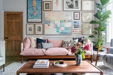 The drawing room with a pink sofa and gallery wall