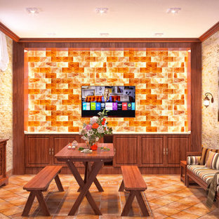 Foto de sótano con ventanas rústico, de tamaño medio, sin chimenea, con paredes beige, suelo de baldosas de terracota y marco de chimenea de piedra