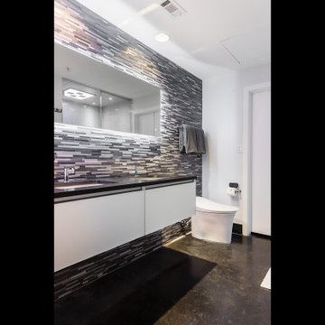 Spacious Floating Vanity with Kohler Composed(R) Faucets and Veil(R) Toilet