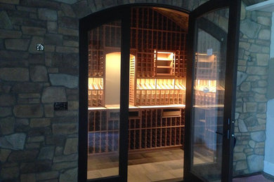 Photo of a large transitional wine cellar in Sacramento with storage racks.