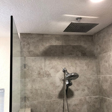 Custom zero entry, ceiling mounted shower head and linear drain bathroom