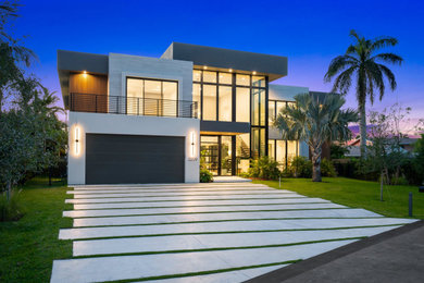 Example of a large trendy two-story exterior home design in Miami