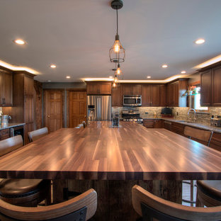 Large rustic kitchen pantry appliance - Inspiration for a large rustic l-shaped porcelain floor kitchen pantry remodel in Milwaukee with an undermount sink, flat-panel cabinets, medium tone wood cabinets, granite countertops, beige backsplash, ceramic backsplash, stainless steel appliances and an island