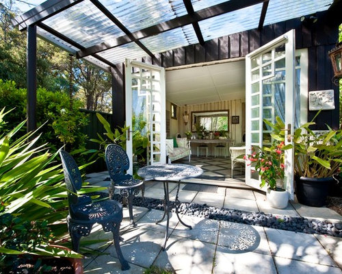 Eclectic Patio Auckland Mid-sized eclectic backyard patio idea in Perth with stamped concrete and an awning