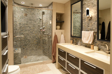 This is an example of a mid-sized contemporary master bathroom in Other with flat-panel cabinets, dark wood cabinets, an alcove shower, gray tile, stone tile, beige walls, ceramic floors, an undermount sink, quartzite benchtops, a hinged shower door and white benchtops.