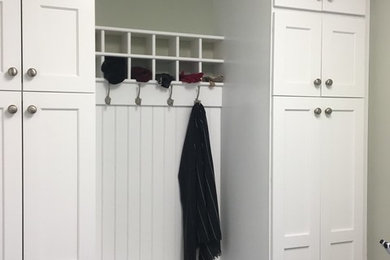 Design ideas for a mid-sized traditional mudroom in Philadelphia with green walls and a single front door.