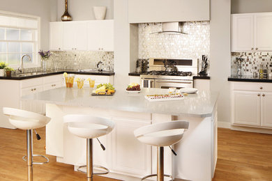 Large minimalist l-shaped light wood floor eat-in kitchen photo in Miami with an undermount sink, beaded inset cabinets, white cabinets, quartz countertops, metallic backsplash, glass tile backsplash, stainless steel appliances and an island