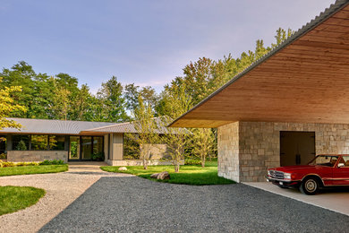 Large farmhouse beige one-story mixed siding house exterior photo in Other with a hip roof, a metal roof and a gray roof