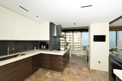 Mid-sized trendy u-shaped travertine floor and beige floor eat-in kitchen photo in Tampa with an undermount sink, flat-panel cabinets, dark wood cabinets, quartz countertops, gray backsplash, matchstick tile backsplash, stainless steel appliances, a peninsula and white countertops