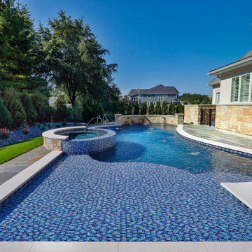 Naperville, IL freeform swimming pool with hot tub, large sunshelf, glass tile
