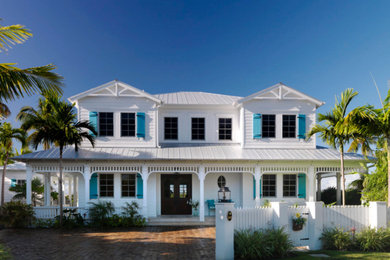 This is an example of a large beach style two-storey white exterior in Miami.