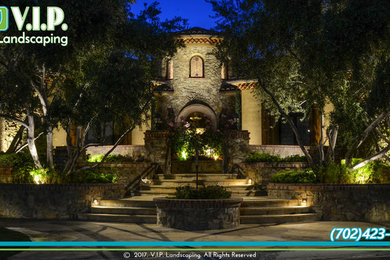 Inspiration for a huge rustic front yard stone landscaping in Las Vegas.