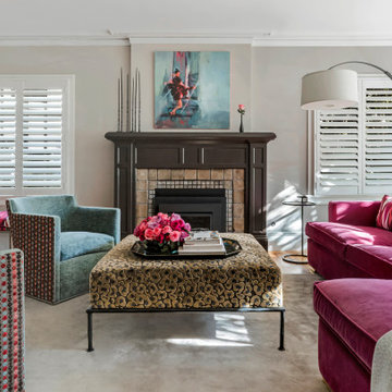 Light neutral walls set of the bright pink velvet sofa and animal print ottoman.