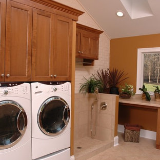 Classic single-wall utility room in Cincinnati with medium wood cabinets, laminate countertops, lino flooring, a side by side washer and dryer, shaker cabinets and brown walls.