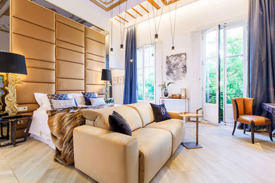 Contemporary master bedroom in Madrid with plywood floors.