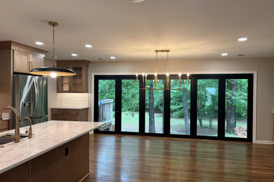 Inspiration for a mid-sized french country medium tone wood floor kitchen/dining room combo remodel in Other