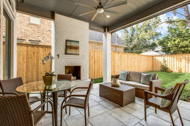 Large transitional backyard concrete paver patio photo in Dallas with a fire pit and a roof extension