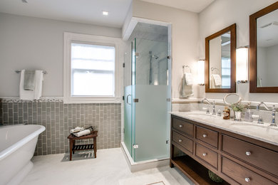 Inspiration for a victorian gray tile and subway tile bathroom remodel in Dallas with an undermount sink, recessed-panel cabinets and dark wood cabinets