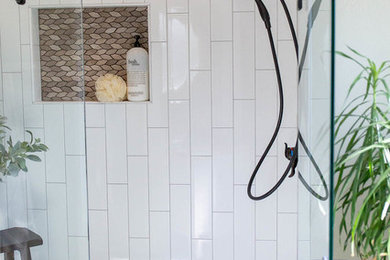 Inspiration for a transitional master white tile and ceramic tile limestone floor alcove shower remodel in Denver with a hinged shower door