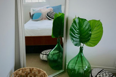 Example of a mid-sized eclectic guest carpeted and beige floor bedroom design in Toronto with white walls