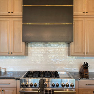 Handcrafted Stainless Steel Range Hood Featuring a Seamless Finish