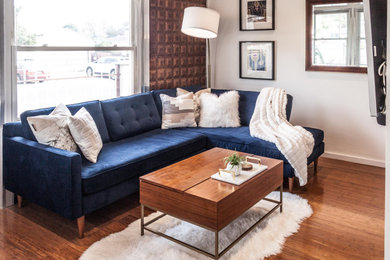 Example of a mid-sized open concept medium tone wood floor, brown floor, coffered ceiling and wall paneling living room design in Los Angeles with white walls, a two-sided fireplace, a stacked stone fireplace and a wall-mounted tv