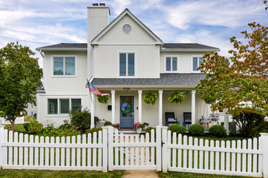 Inspiration for a mid-sized timeless white wood exterior home remodel in DC Metro with a shingle roof and a gray roof