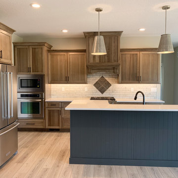 New Home With Warm-Stained Hickory Kitchen and Stylish Bathroom Tile