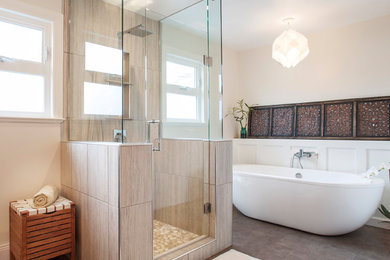 This is an example of a large transitional master bathroom in Other with a freestanding tub, an alcove shower, beige tile, porcelain tile, beige walls, porcelain floors, brown floor and a hinged shower door.